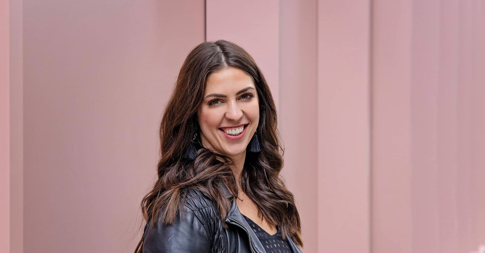 a headshot of Psychotherapist Anna Mathur smiling to the camera