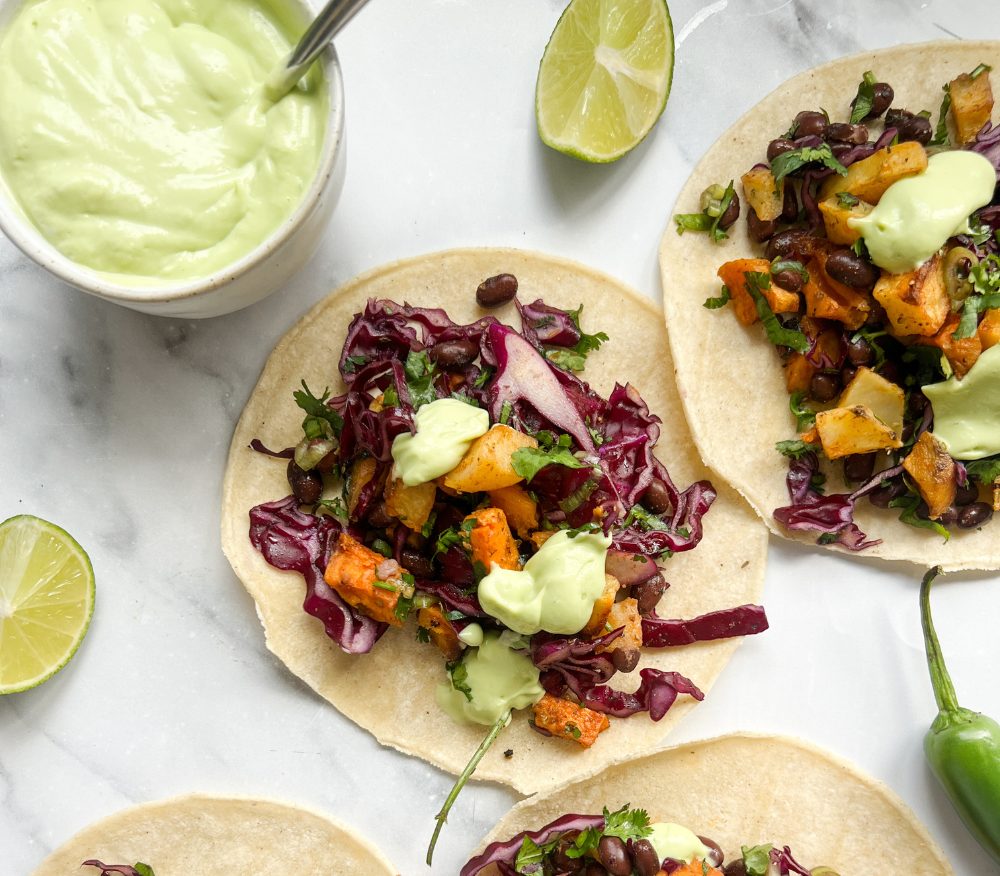 Tacos with sweet potato and black bean filling placed down the middle