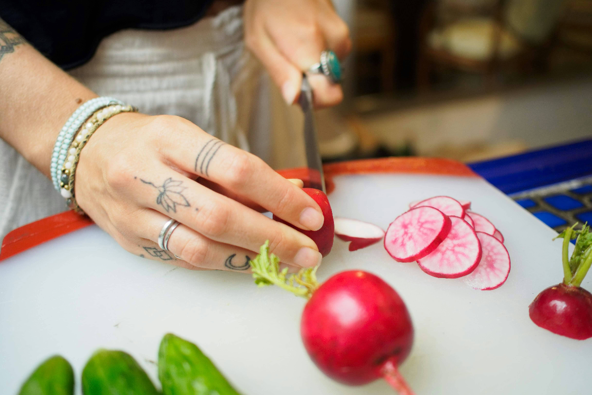 hands-chopping-radishes-and-cucumber