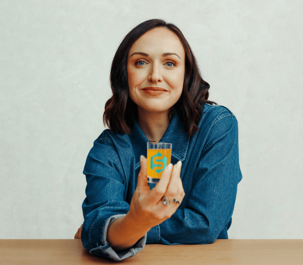 Ruby holding her morning shot of Symprove