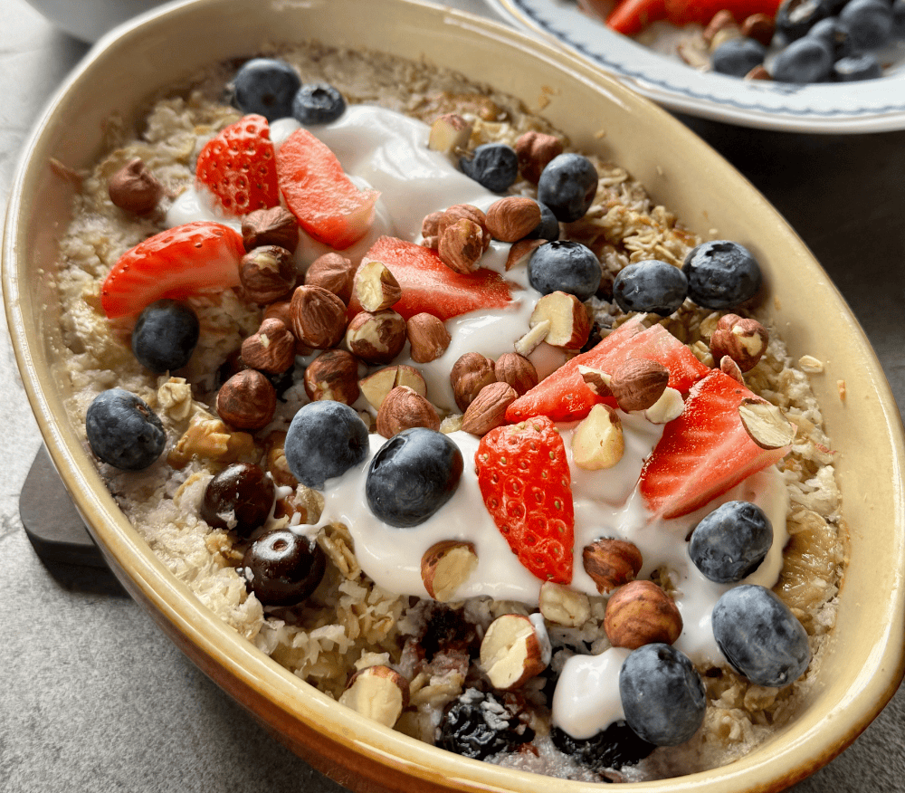 baked oats topped with nuts, berries and yoghurty
