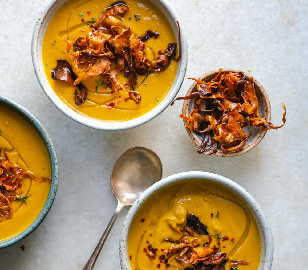 Three bowls of carrot and parsnip soup