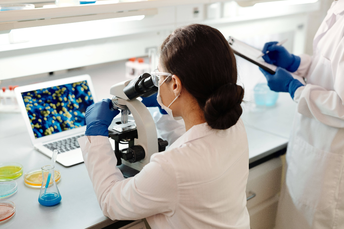 a-researcher-looking-through-a-microscope