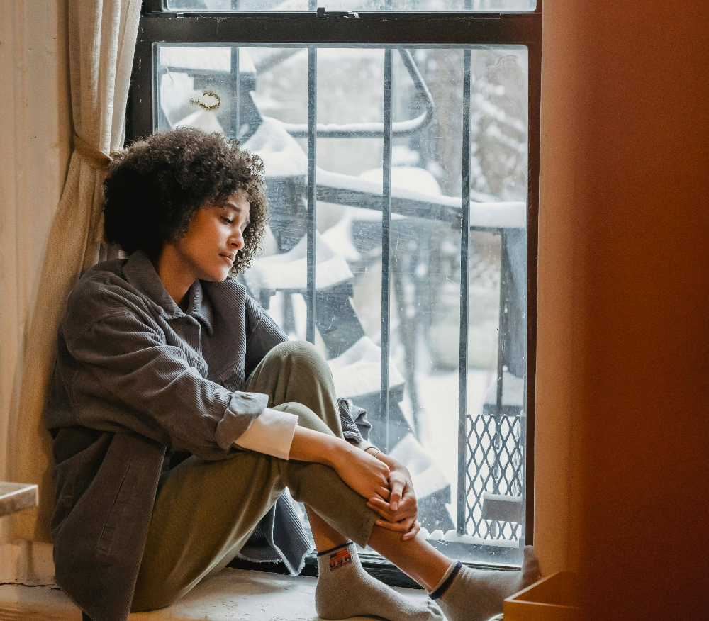 person-loosely-holding-their-knees-in-pain