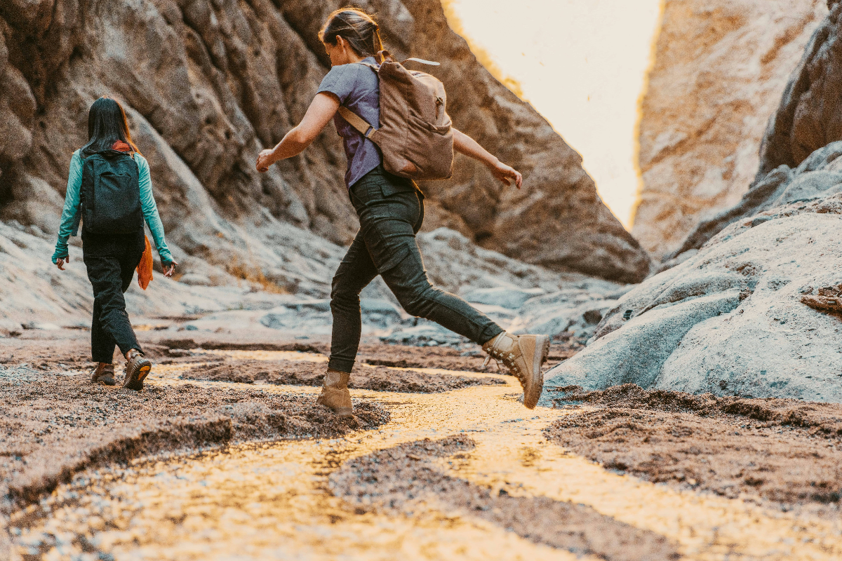 Two-people-exploring-a-canyon