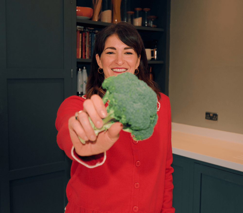 Dietitian Laura Tilt holding broccoli to the camera