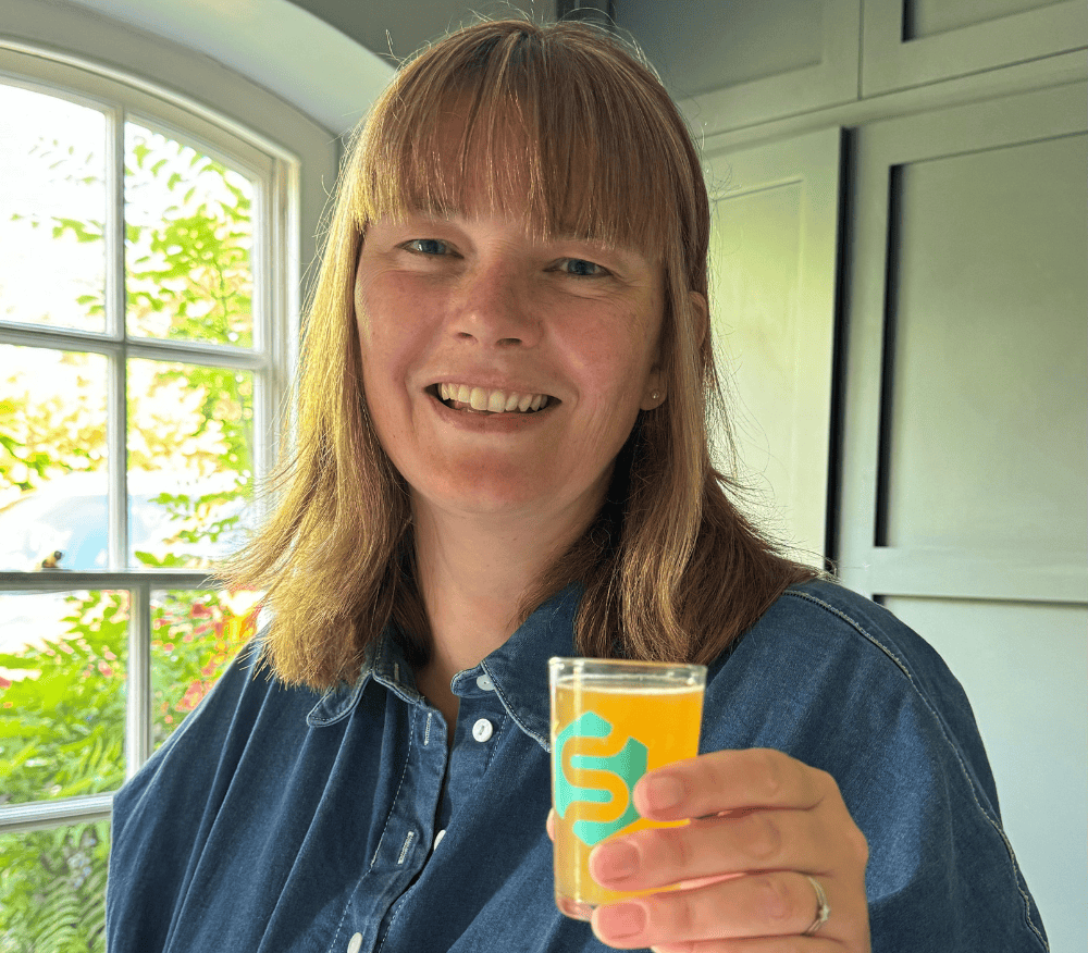 Louise Stanley holding her morning shot of Symprove