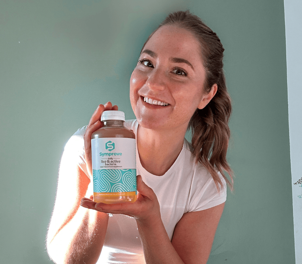 Vanessa holding a bottle of Symprove