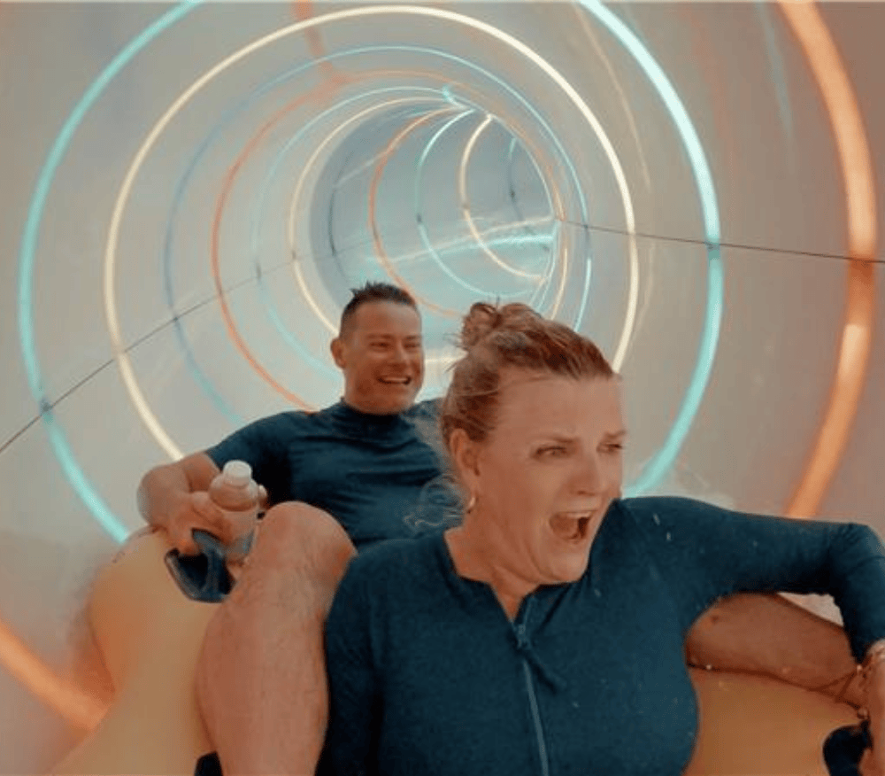 Susannah Constantine and Professor Simon Gaisford on a waterslide with Symprove