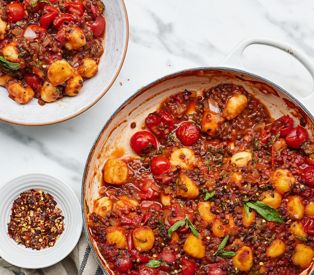 A serving dish loaded with a tomato and gnocchi bake