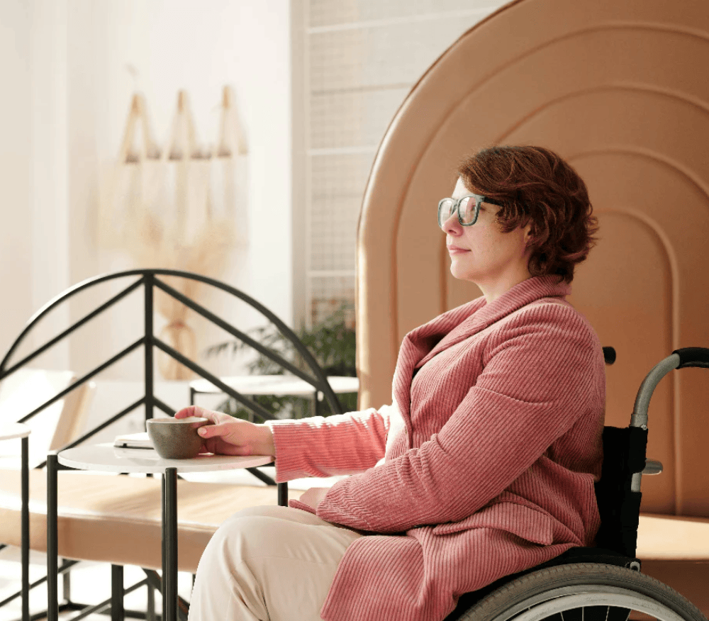 sitting-in-a-wheel-chair-and-enjoying-a-drink-on-a-sunny-morning